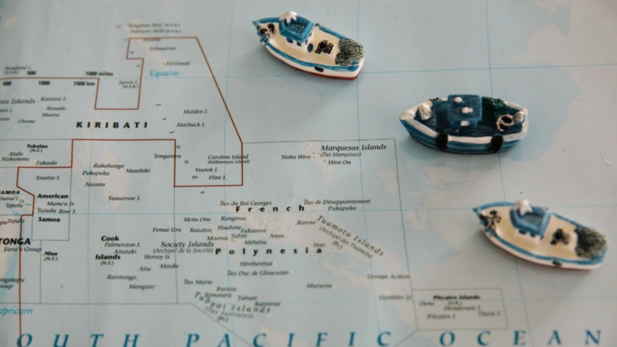 Three small model boats positioned on a map, representing thoughtful ocean cruise planning with Dorian Destinations.