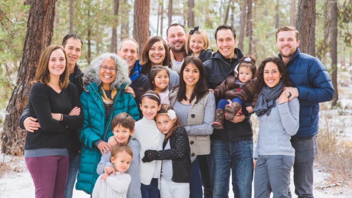 A family portrait in the snow, showcasing togetherness and joy during a winter travel adventure.