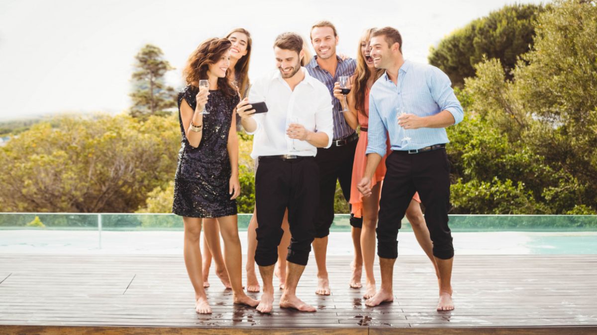 Colleagues enjoying a lively moment together at a pool during a corporate event retreat.