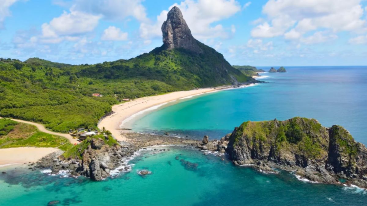Aerial view of the Galápagos Islands showcasing a beach and mountains surrounded by the ocean.