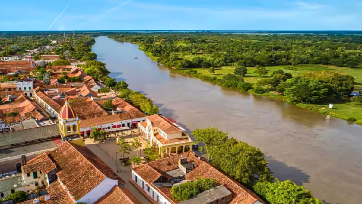 Aerial view of a town alongside the Magdalena River in Colombia, highlighting the scenic landscape for planning an AmaWaterways Magdalena River Cruise.