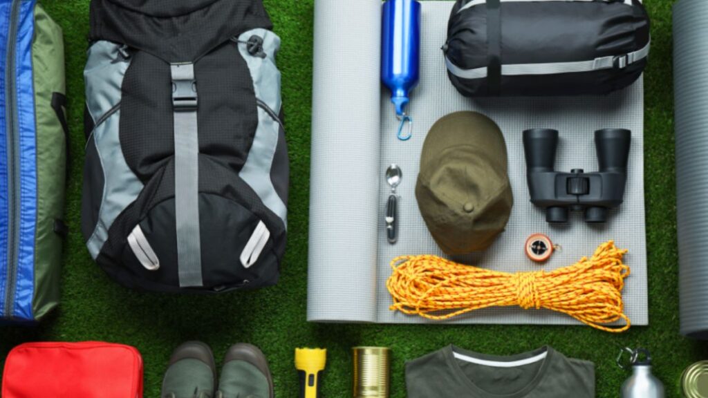 A variety of camping gear, including tents and backpacks, arranged neatly for expedition preparation.