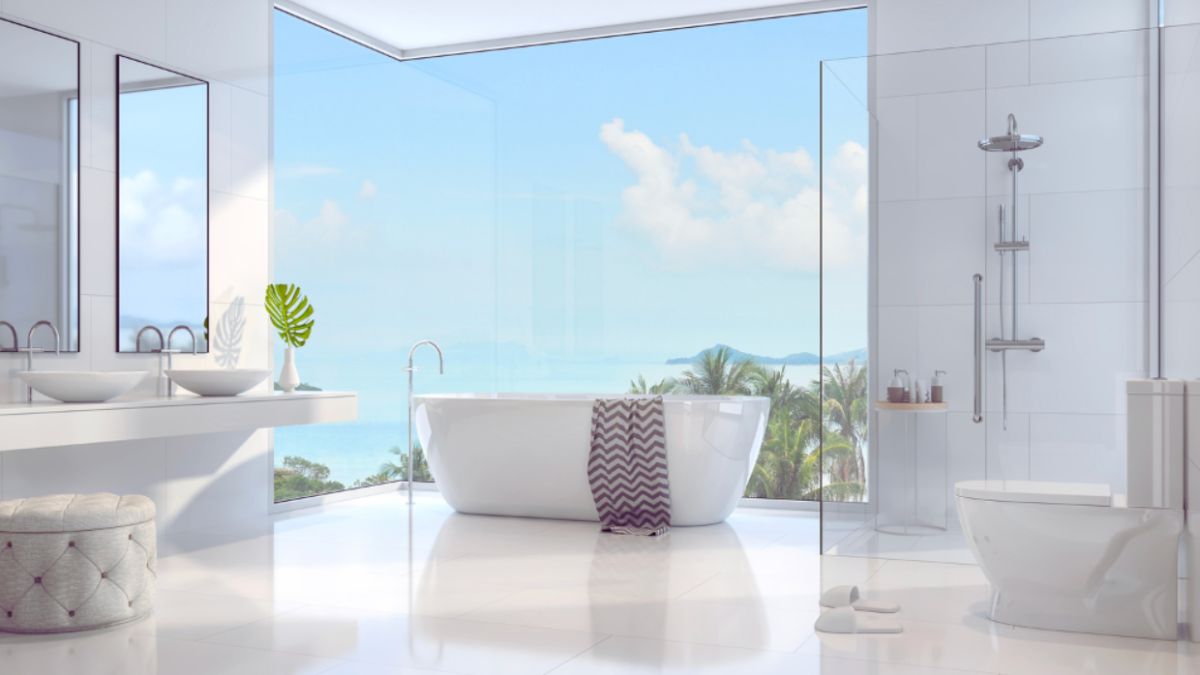 A luxurious bathroom with a large tub and expansive window overlooking the Galápagos Islands.