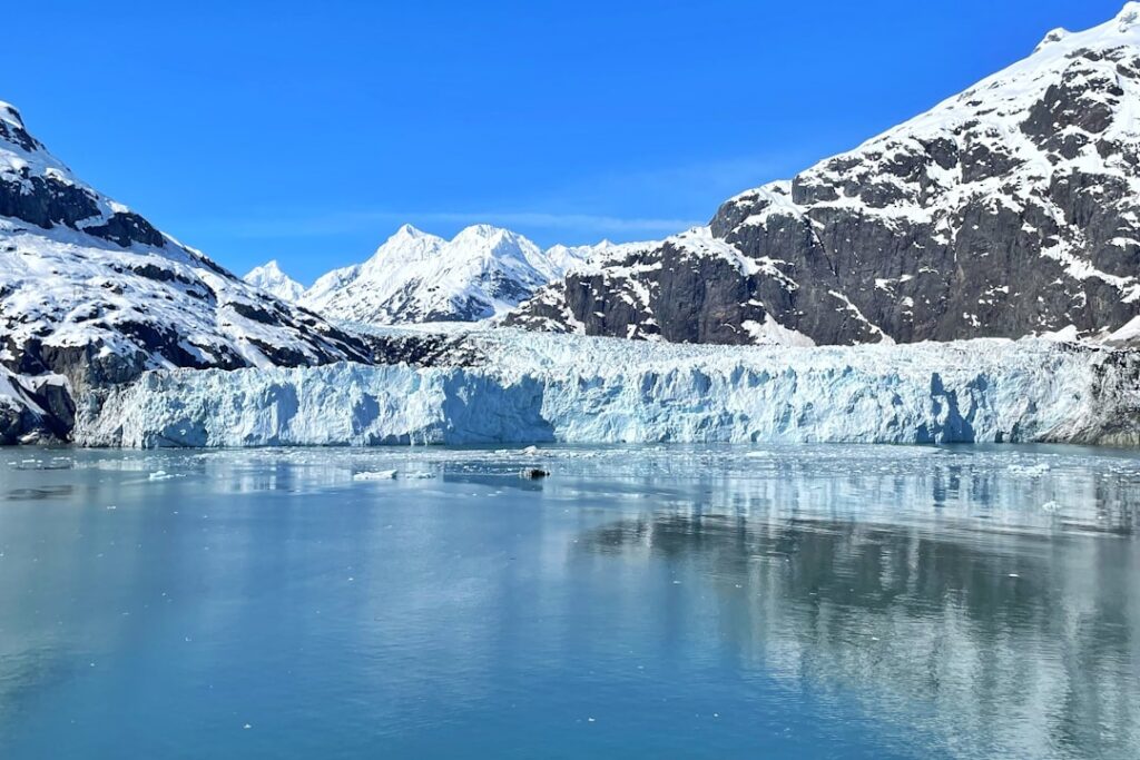 A large glacier with mountains in the background in Alaska