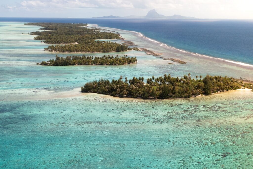 Aerial view of a remote French Polynesian atoll in the middle of the ocean