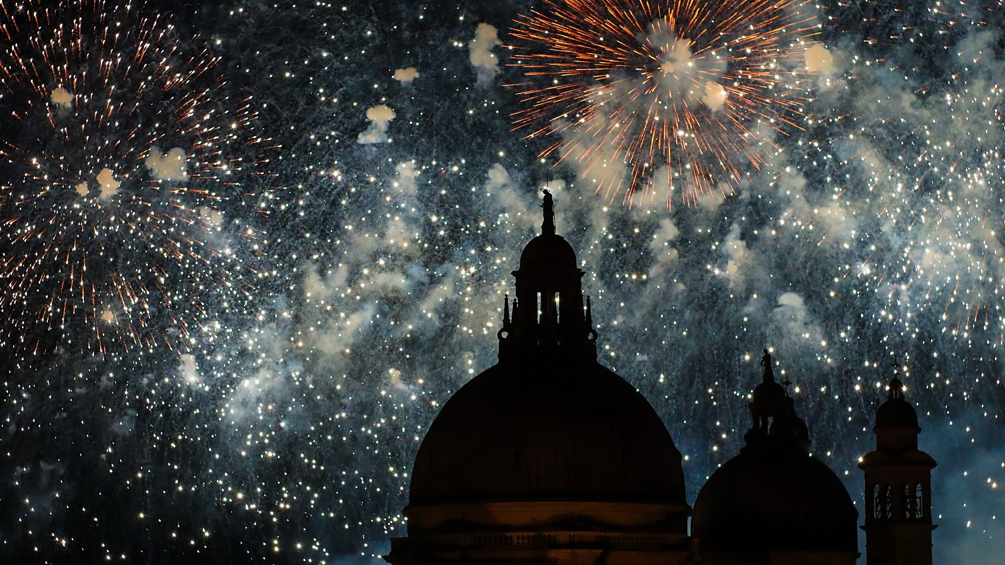 Fireworks bursting over the domes of Santa Maria della Salute during the Redentore festival, Venice