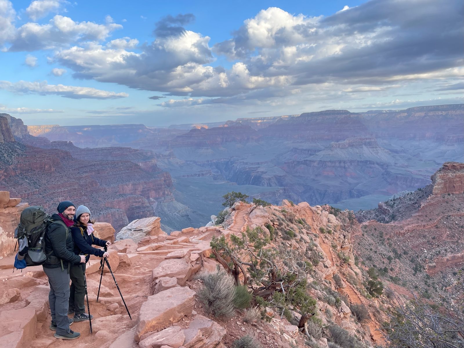 Hikers at a canyon overlook at sunrise