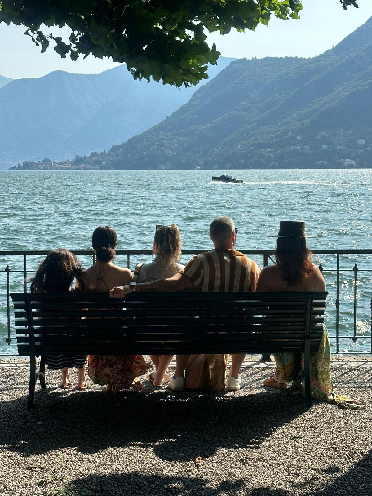 Family group seated together overlooking an Italian lake