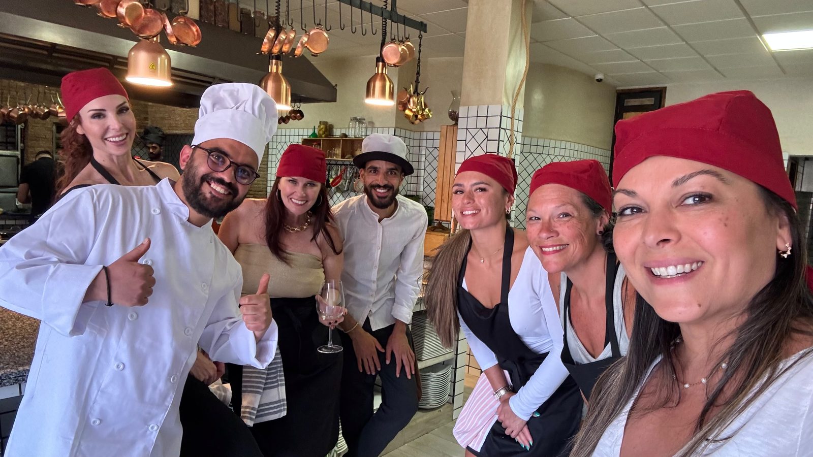 Guests in chef's whites during a hands-on cooking class