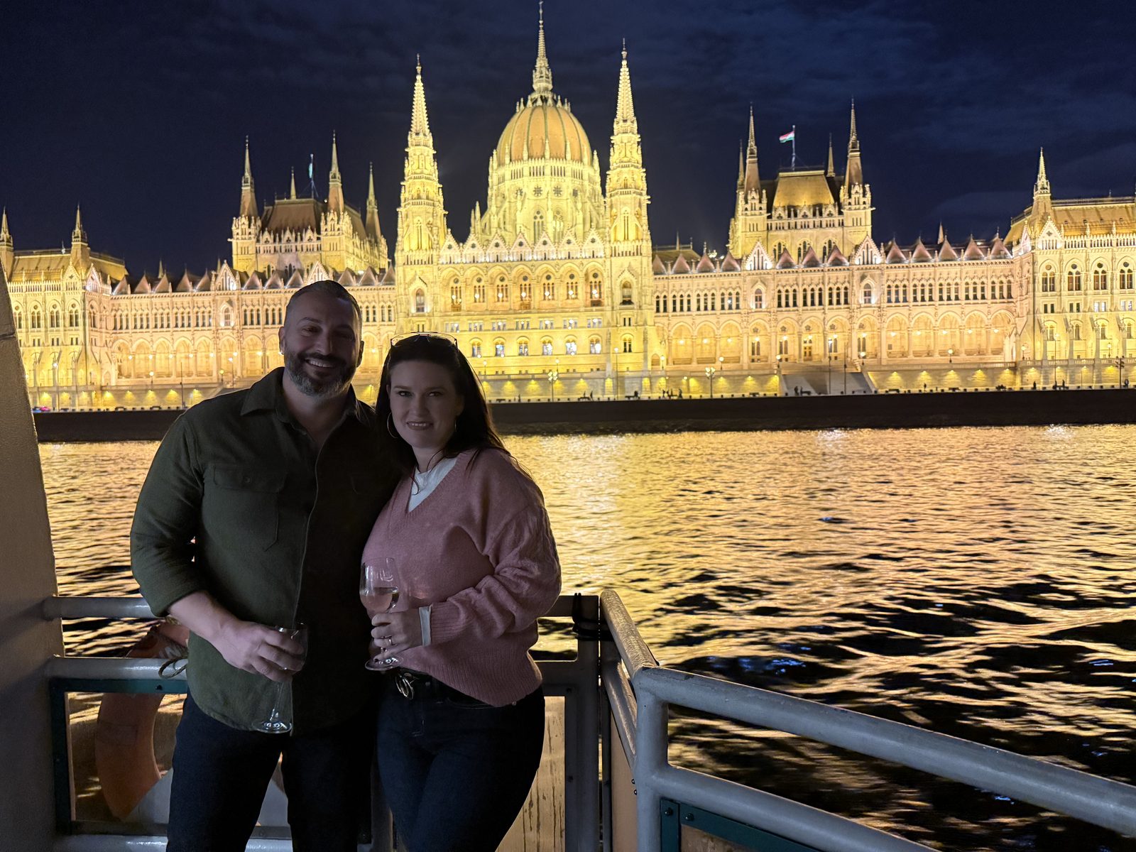 Evening on a river cruise deck with the Hungarian Parliament lit across the Danube