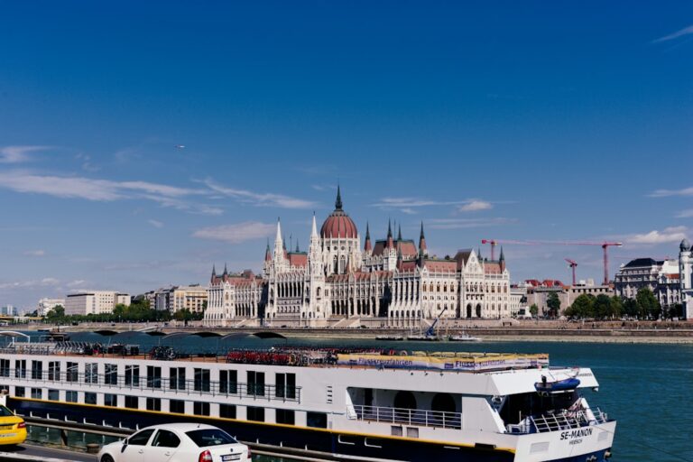 Luxury river cruise ship sailing past the Hungarian Parliament building on the Danube
