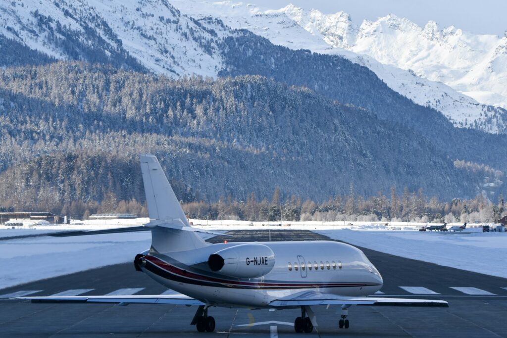 Four Seasons Grand Horizons: 24 Days, 9 Destinations, One Private Jet 7 Private jet on a snowy runway with mountains behind, representing ultra-luxury private jet travel