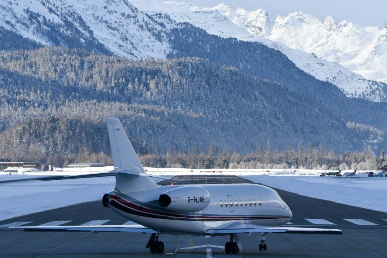 Private jet on a snowy runway with mountains behind, representing ultra-luxury private jet travel
