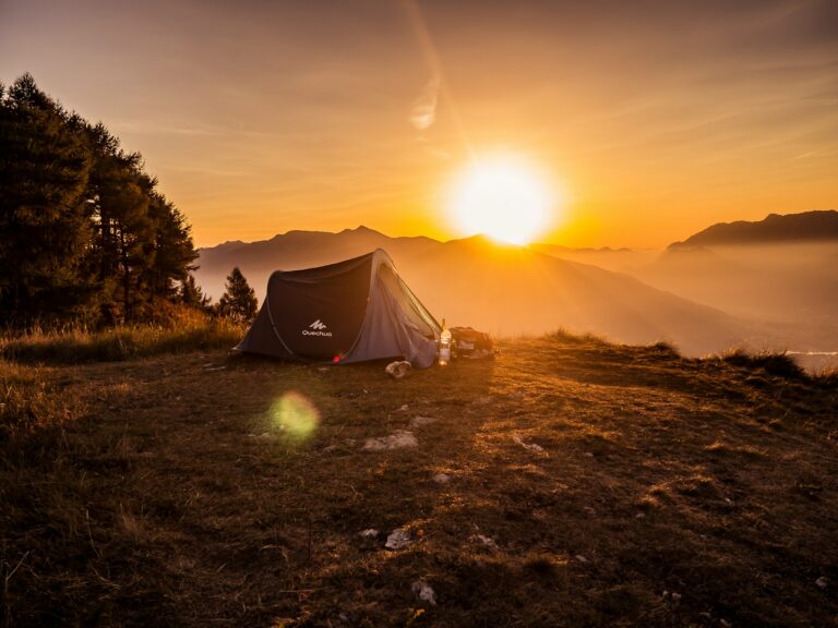 Tent on a mountain at sunrise, representing restorative wilderness and luxury under-canvas travel