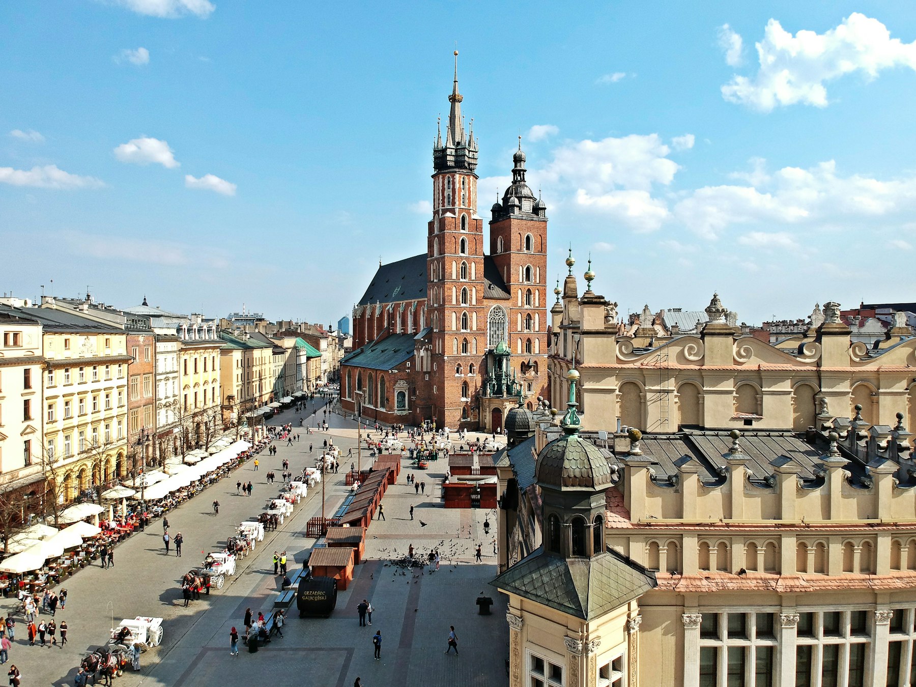 The main market square in Krakow with the town hall tower behind it, one of the best places to visit in Europe once the September light arrives
