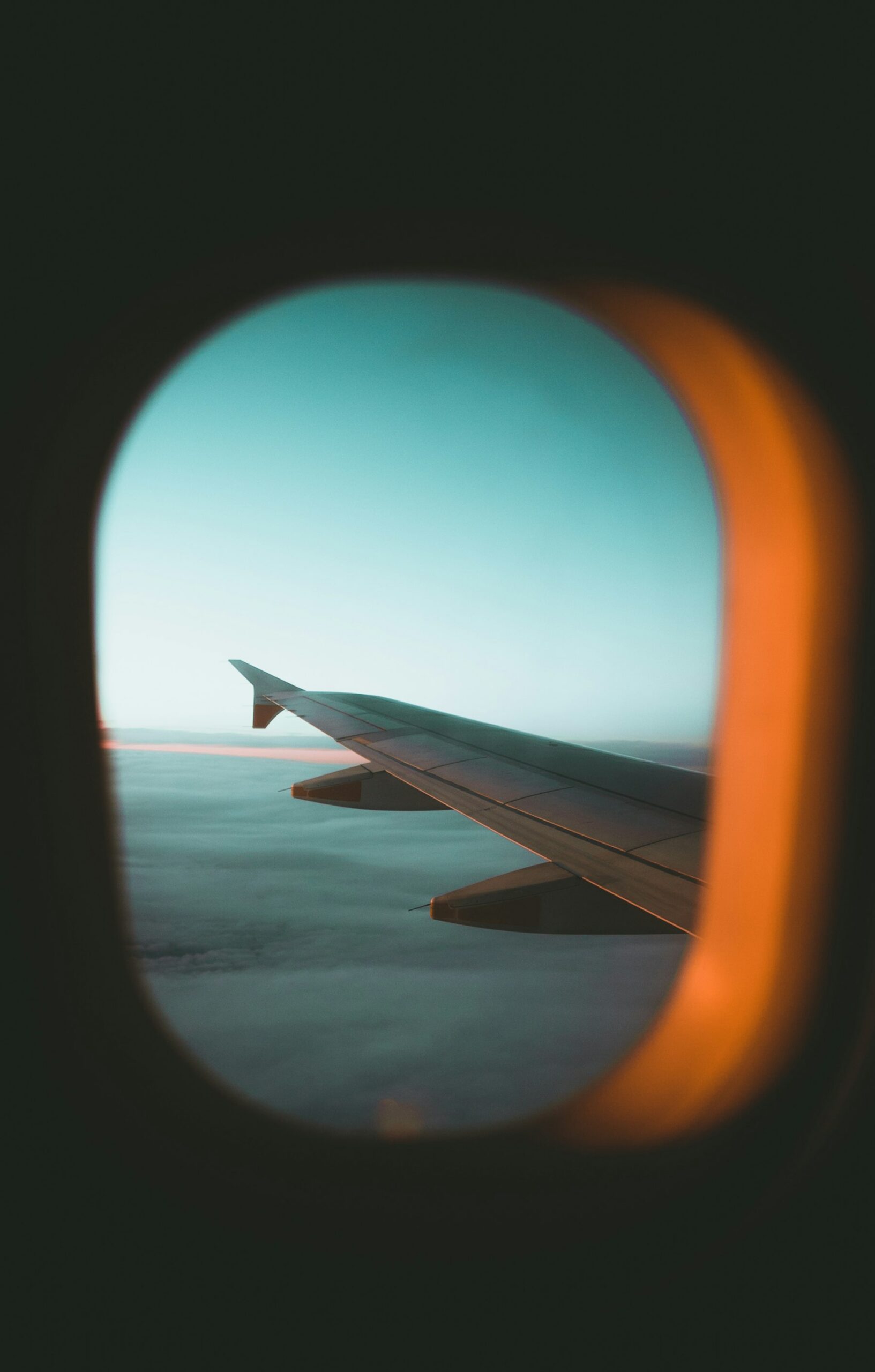 The view from an airplane window at dawn on an early morning departure, often the cheapest flight of the day