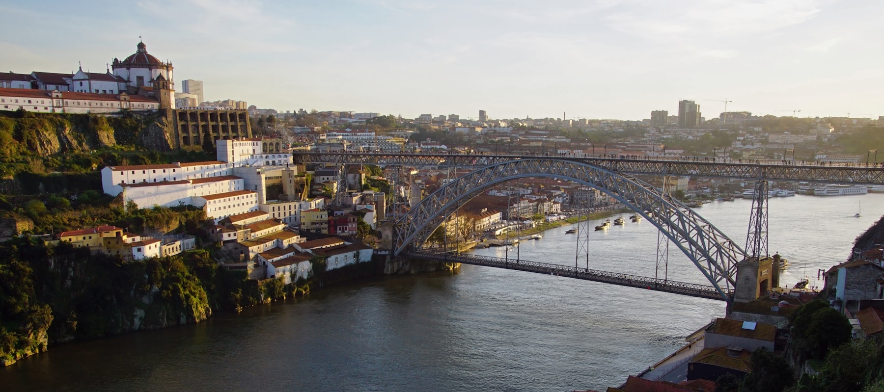 The Luís I bridge spanning the Douro river at dusk in Porto, where most Douro river cruise itineraries begin.