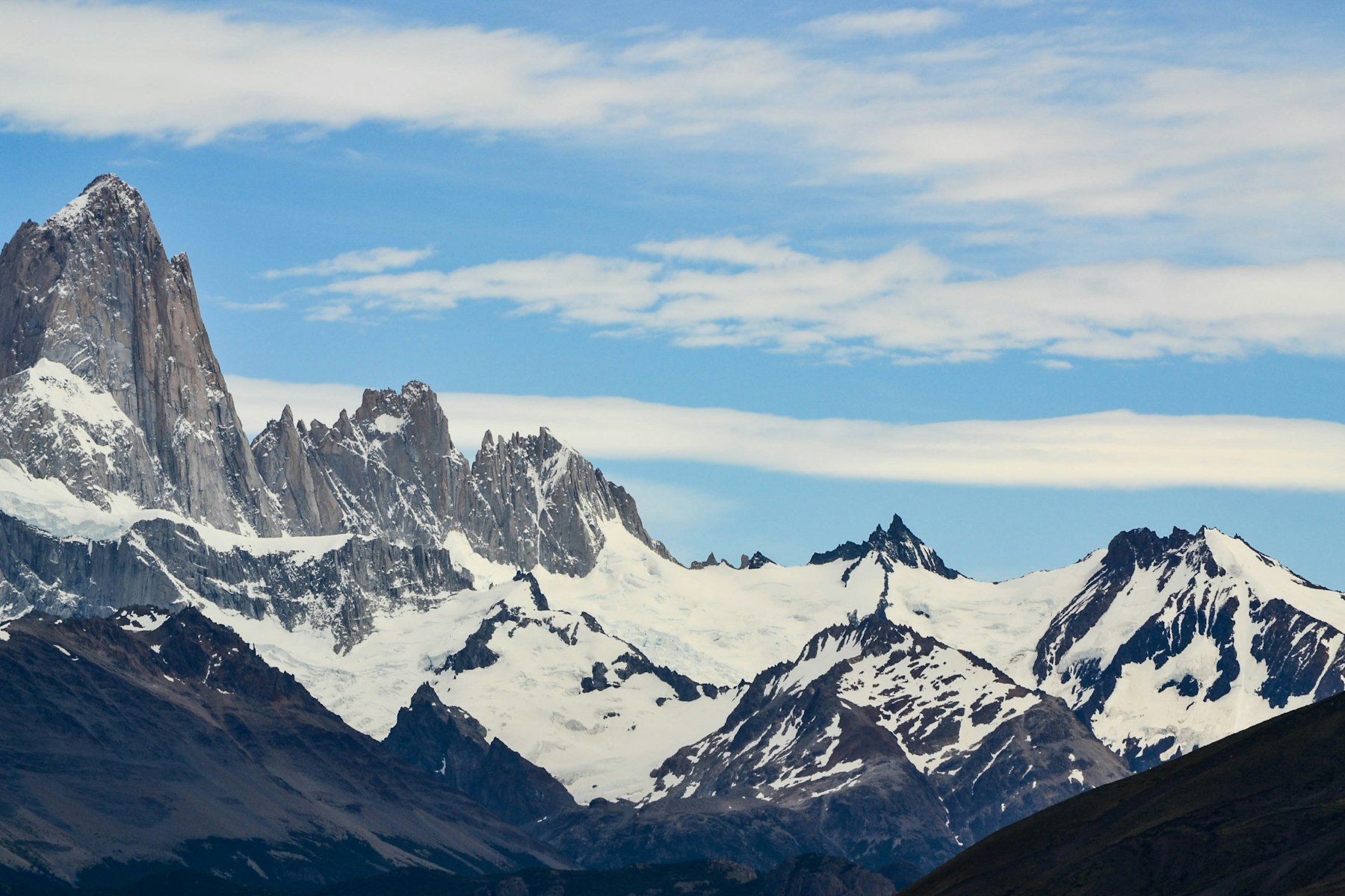 Snow-covered granite spires above El Chalten in Argentina, the trekking base for hiking Patagonia on day routes.