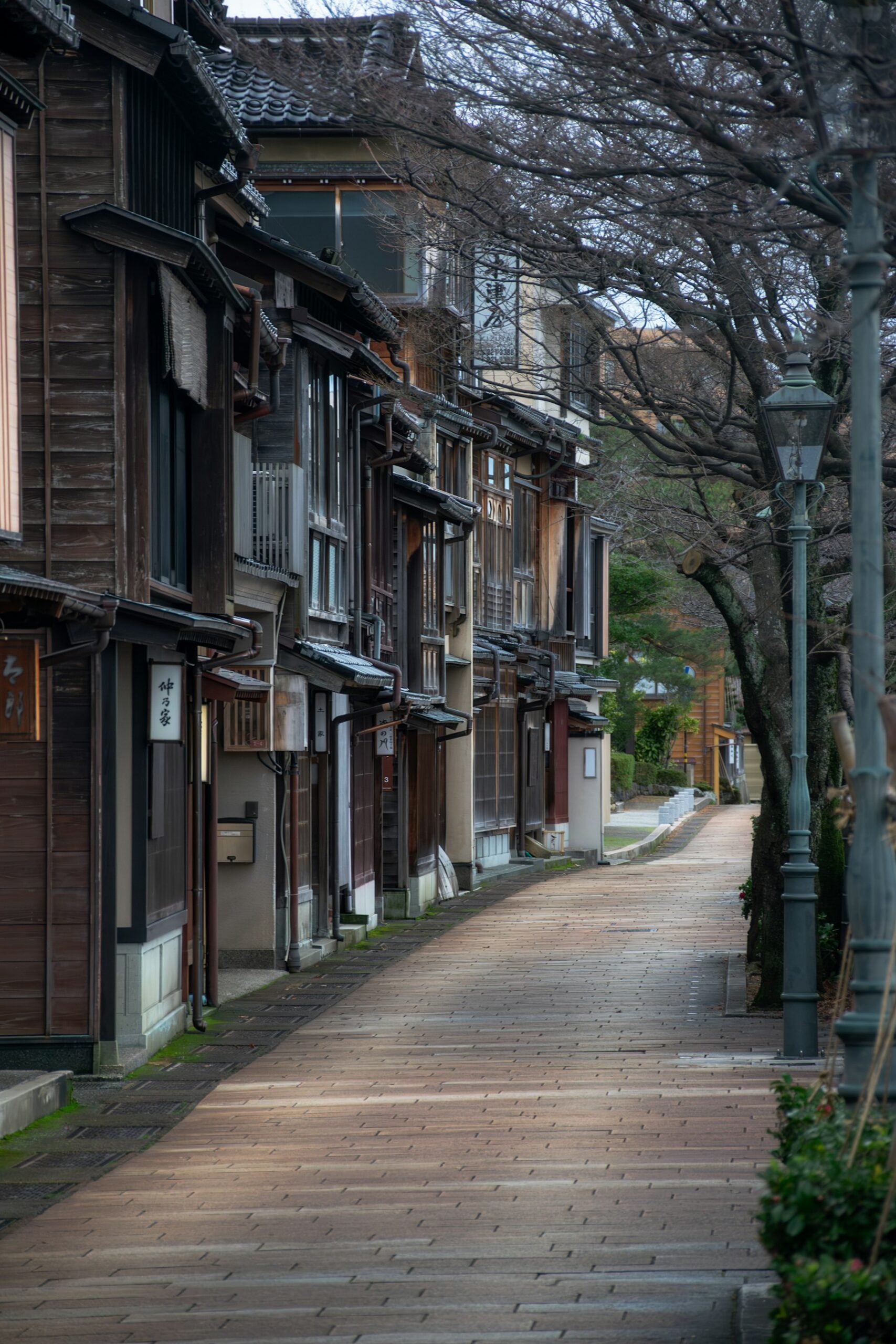 Wooden teahouse buildings lining a street in Kanazawa, the Hokuriku detour we add to a 2 week Japan itinerary