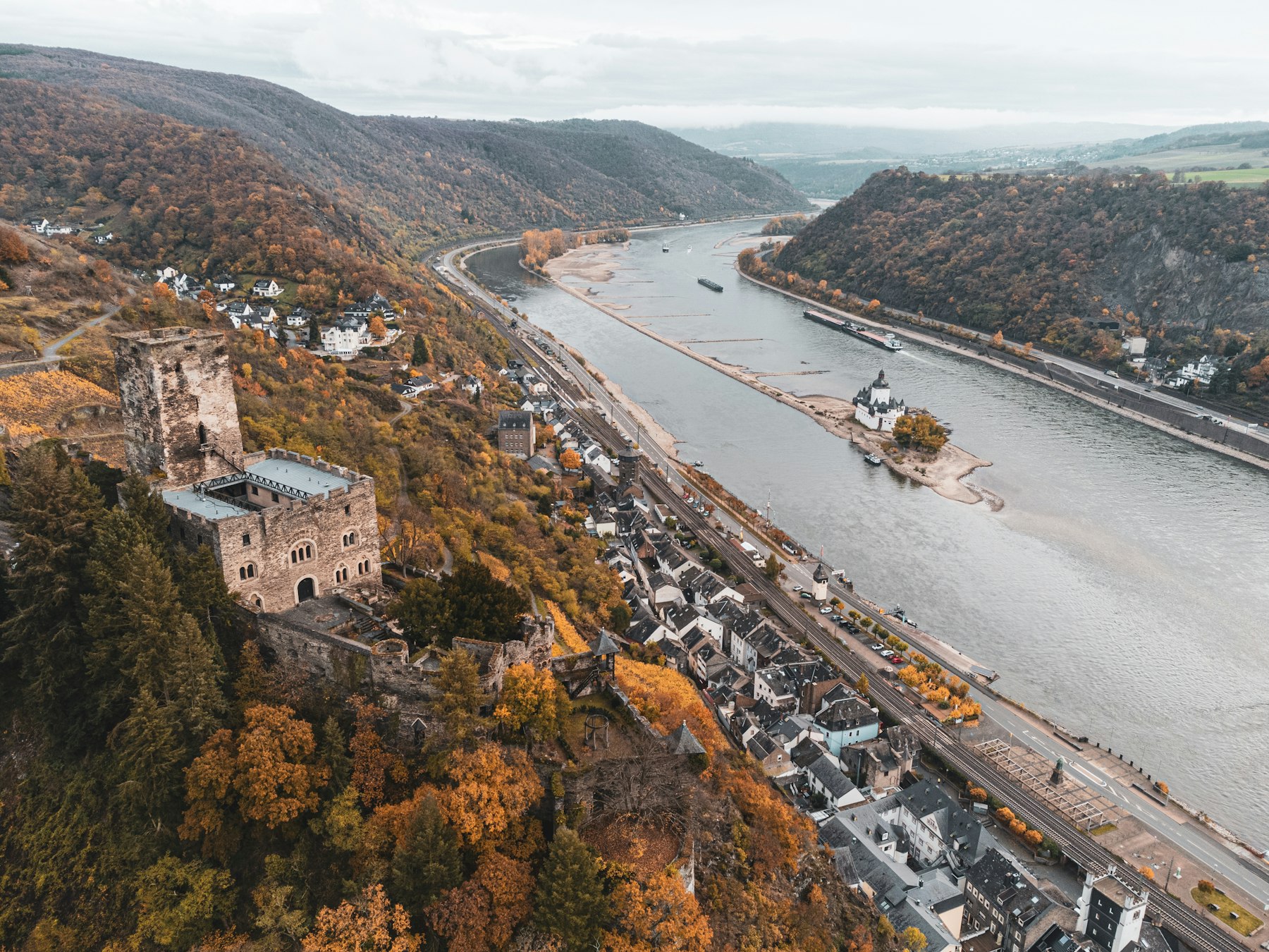 Aerial view of the Rhine curving past a riverside town in Rhineland-Palatinate, the stretch that defines a Rhine river cruise.