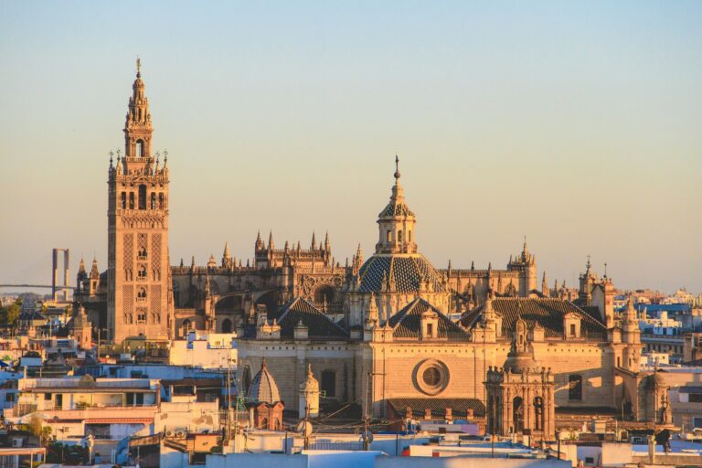 Seville Cathedral and the Giralda tower rising above the city rooftops, the third stop on this Spain and Portugal itinerary.