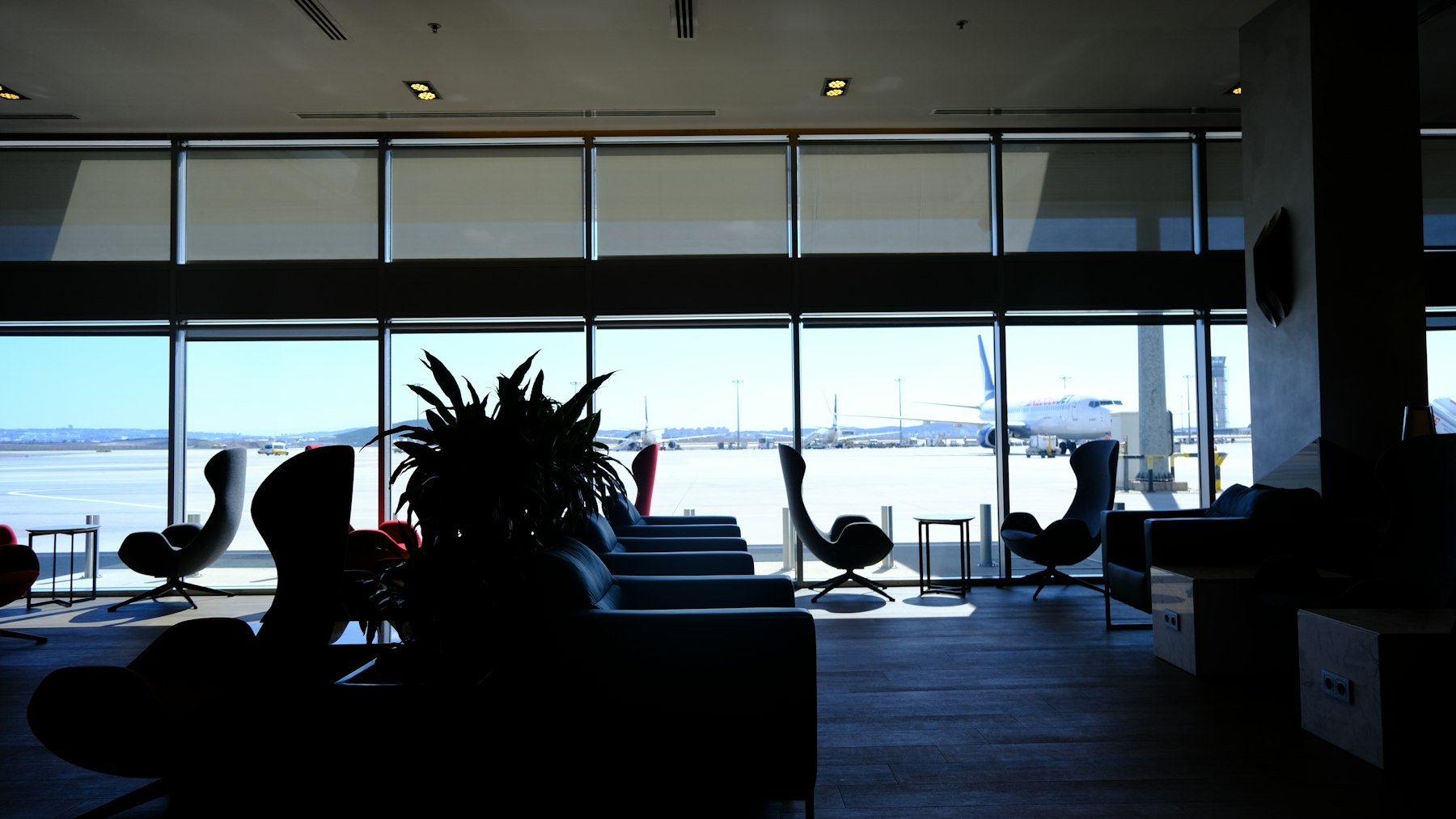 A quiet airport lounge with floor-to-ceiling windows in Istanbul, the kind of perk a travel rewards credit card is usually marketed on