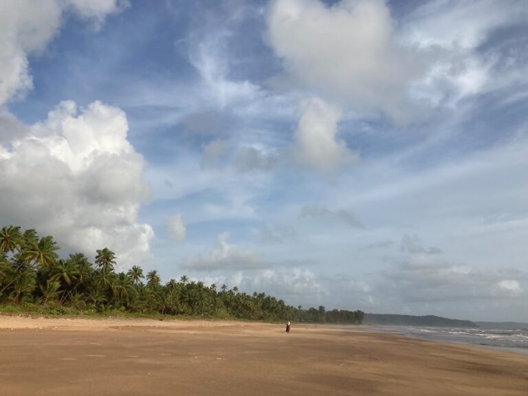 Traveler walking along the Konkan coast in Maharashtra, India, near Tarkarli