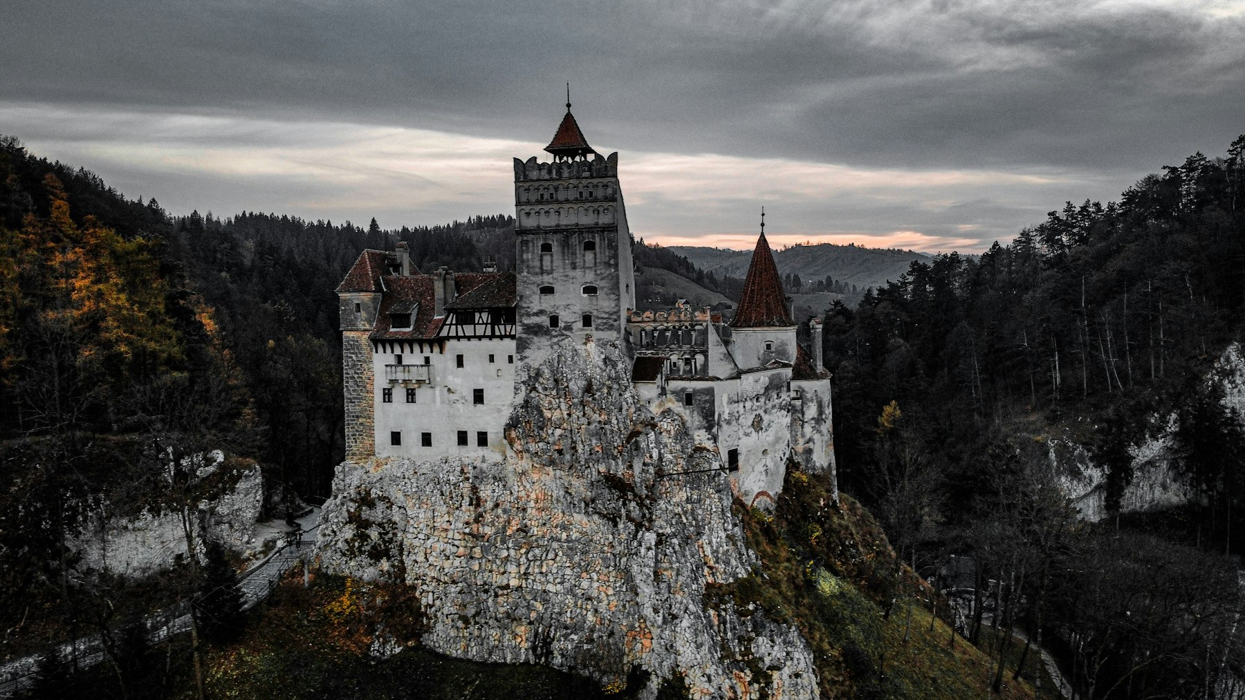 Bran Castle on its rock in Transylvania, the stop most travellers plan a Romania itinerary around and the one UNESCO has never inscribed