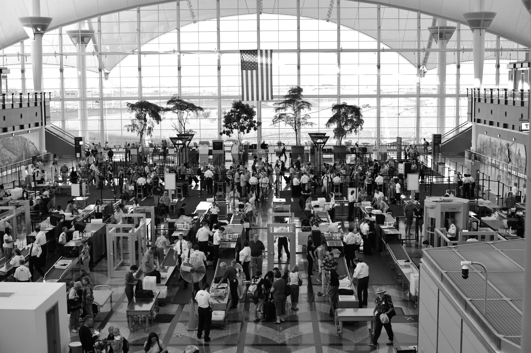 Travellers filing through the security checkpoint lanes in the main terminal at Denver International Airport, where TSA PreCheck benefits buy a separate and shorter queue.