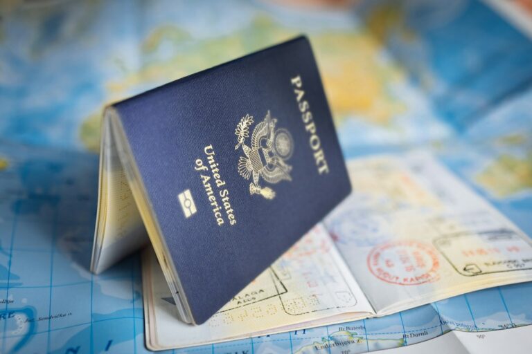 U.S. passport book resting on a world map, illustrating a passport validity check before booking travel